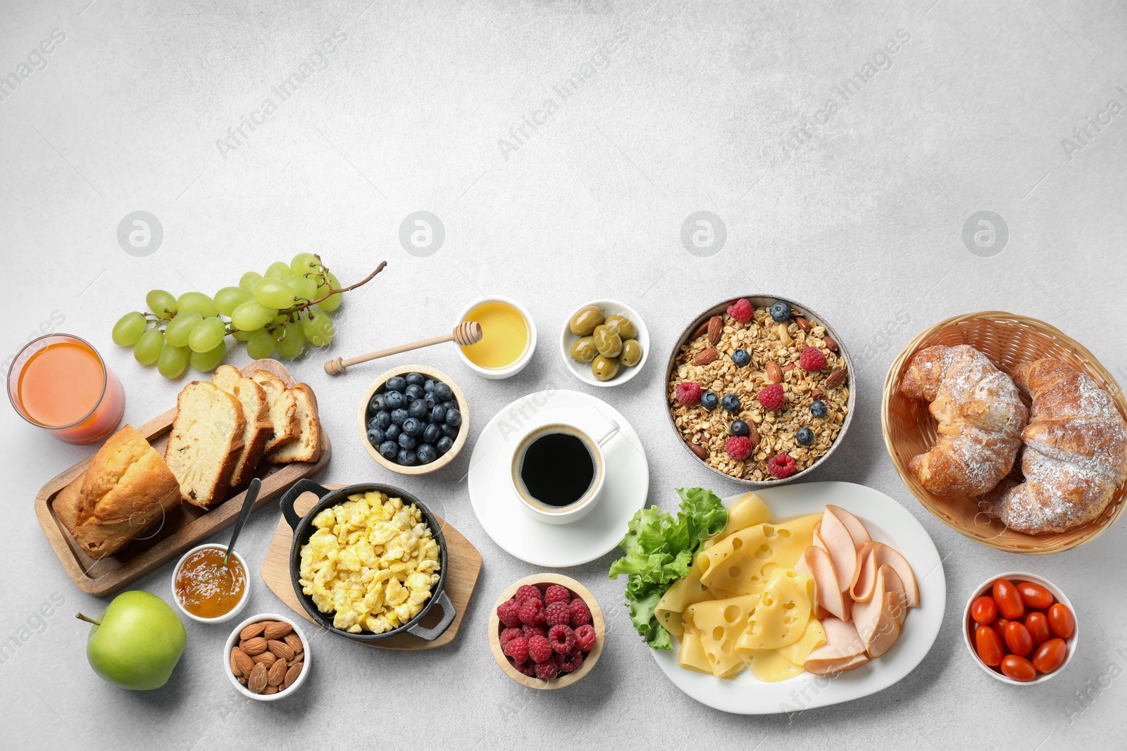 Photo of Tasty breakfast. Flat lay composition with many different food and drinks on grey textured table. Space for text