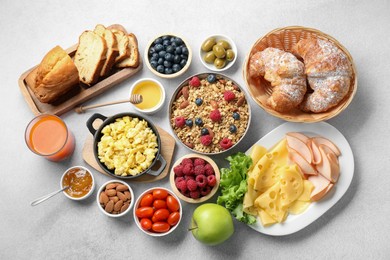 Photo of Tasty breakfast. Flat lay composition with many different food and drinks on grey textured table