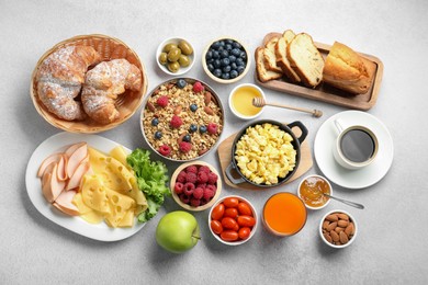 Photo of Tasty breakfast. Flat lay composition with many different food and drinks on grey textured table