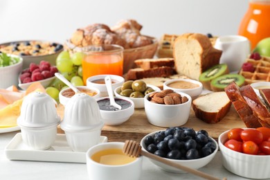 Photo of Different meals served for breakfast on white table