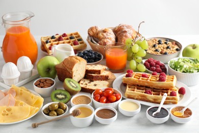 Photo of Different meals served for breakfast on white table