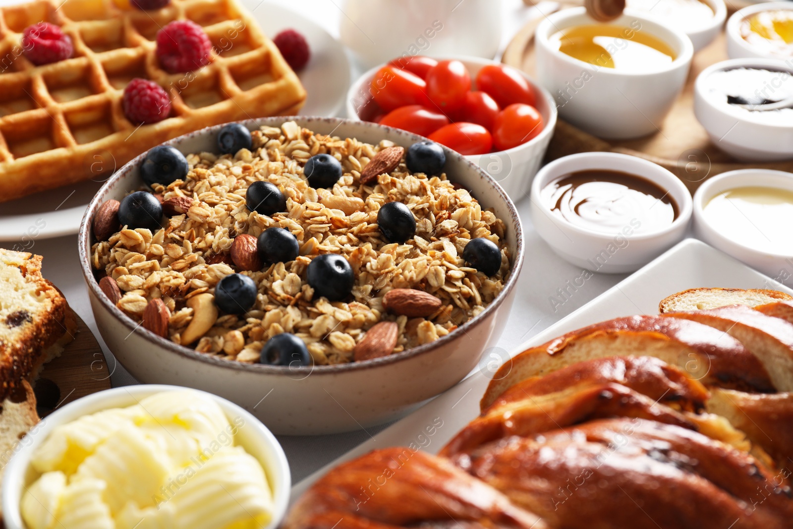 Photo of Different meals served for breakfast on white table, closeup. Buffet menu