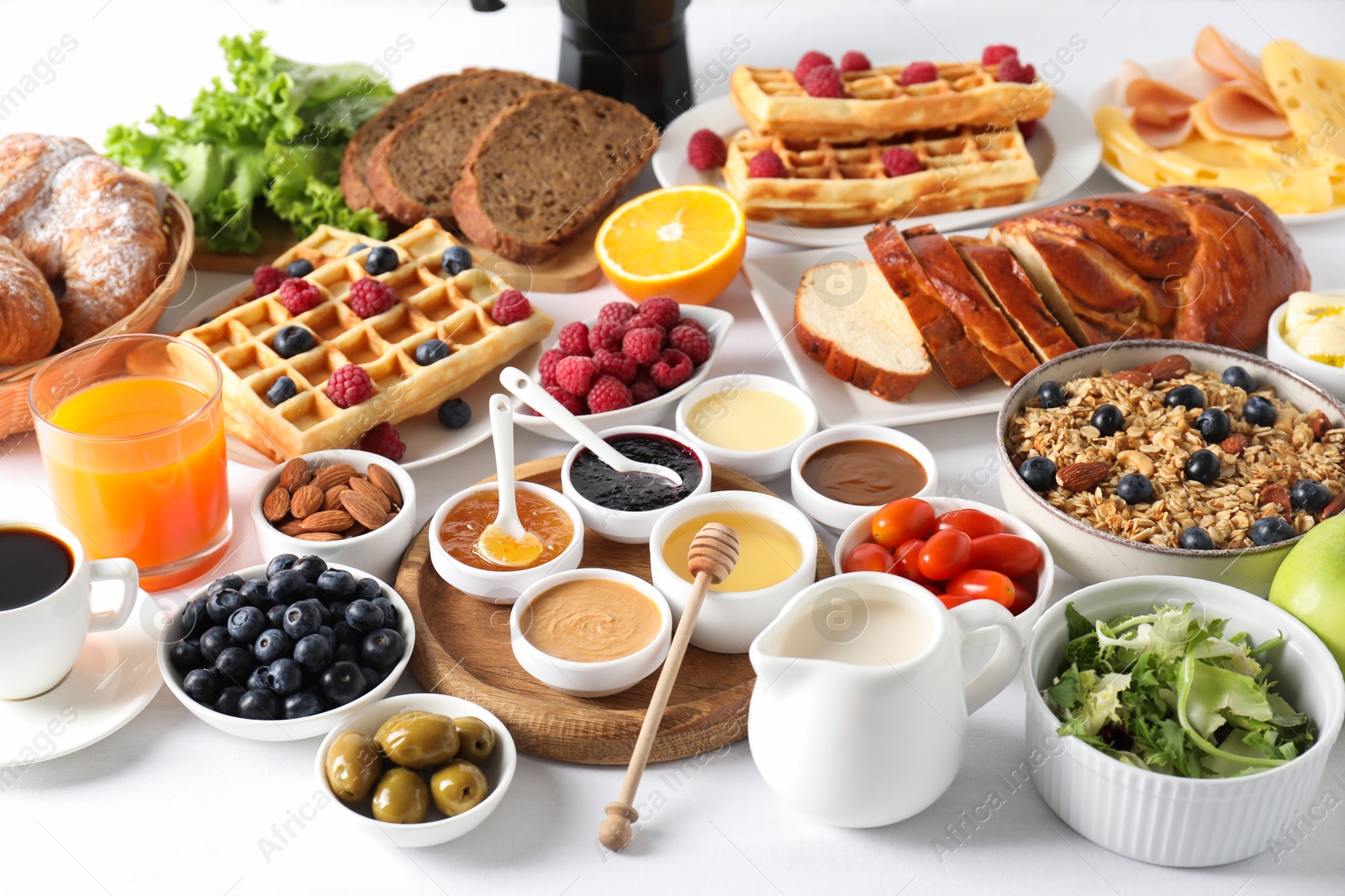 Photo of Different meals served for breakfast on white table