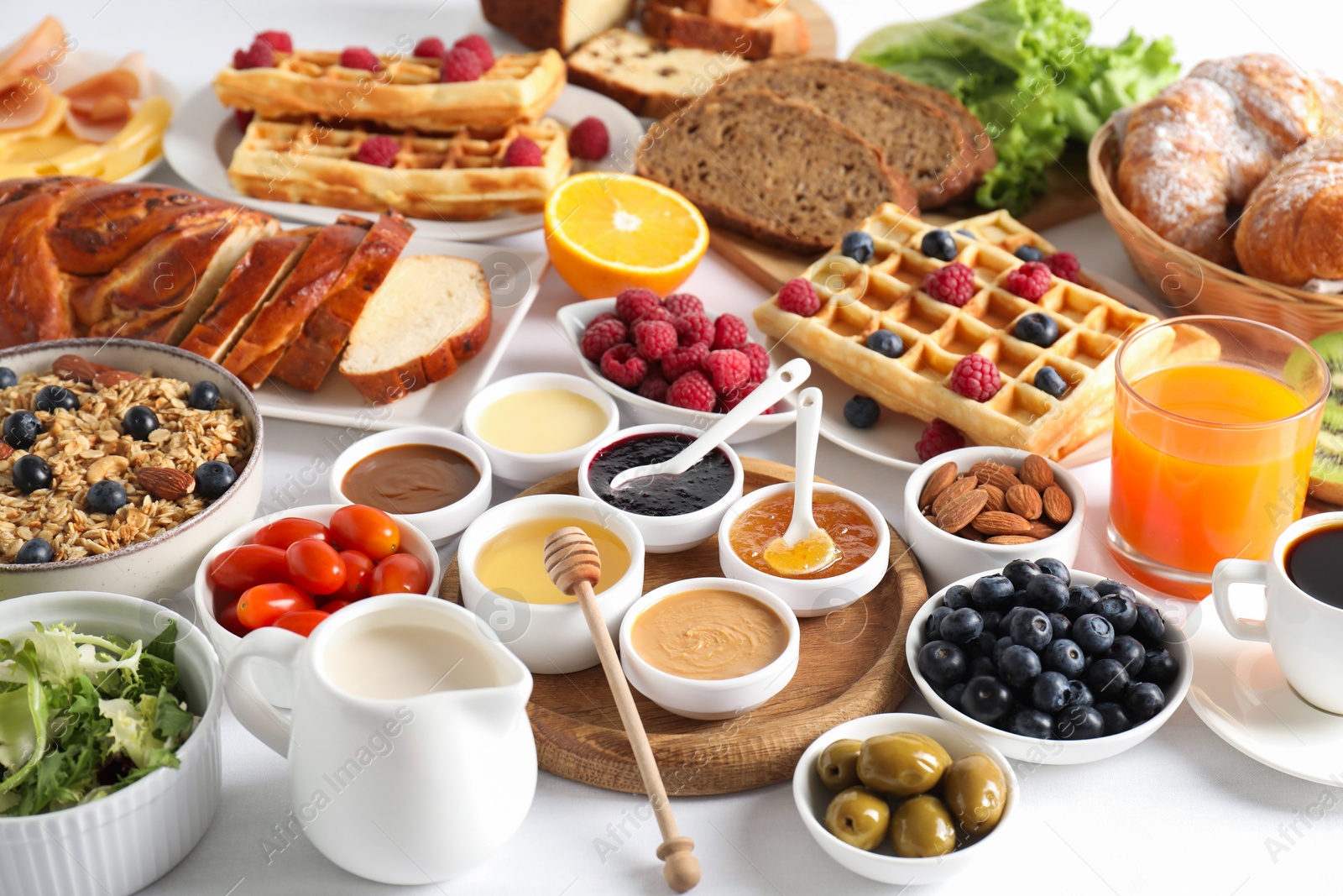 Photo of Different meals served for breakfast on white table