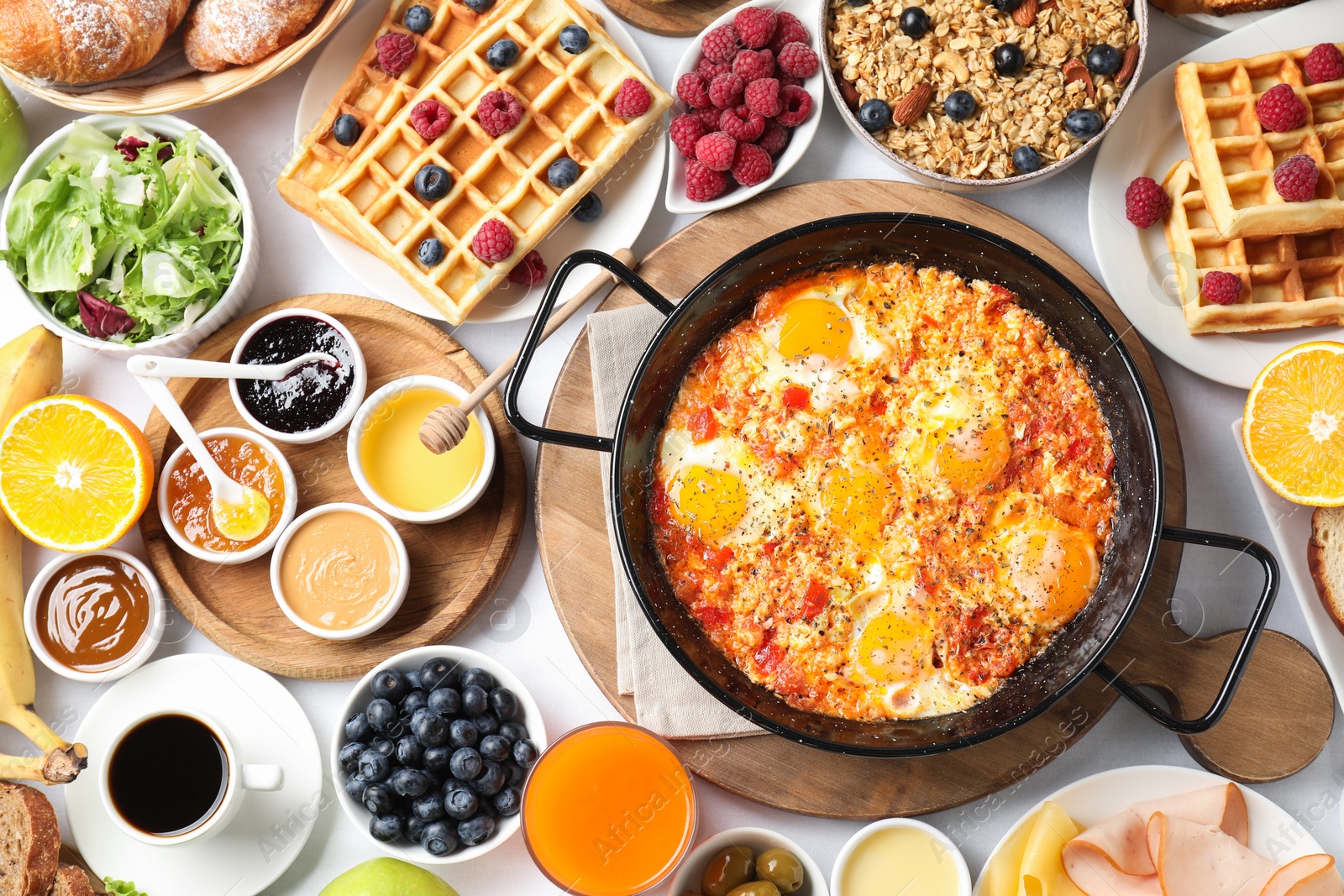 Photo of Different meals served for breakfast on white table, flat lay