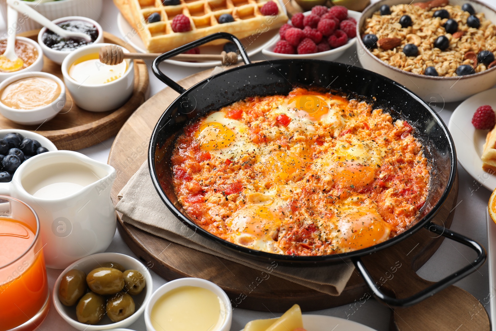 Photo of Different meals served for breakfast on white table, closeup