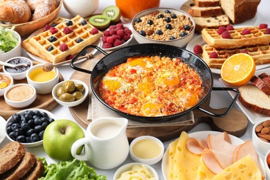 Photo of Different meals served for breakfast on white table