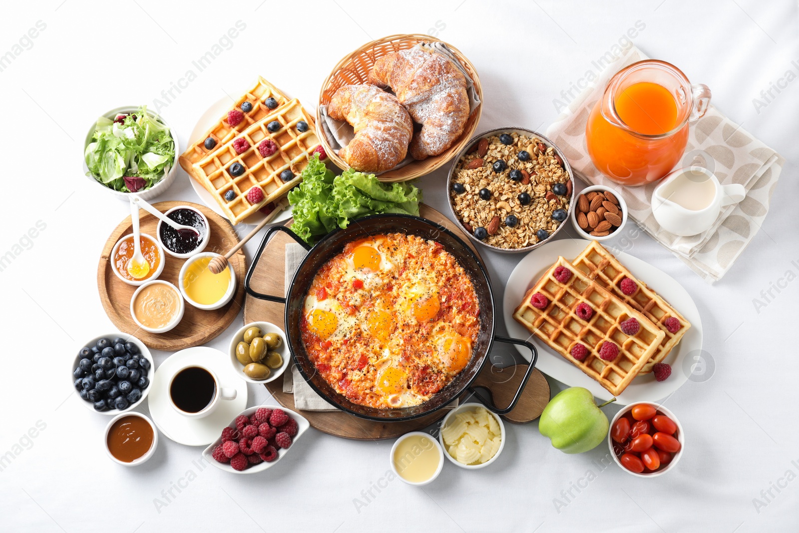 Photo of Different meals served for breakfast on white table, flat lay