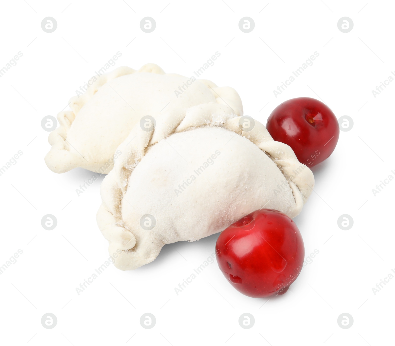 Photo of Frozen dumplings (varenyky) and fresh cherries isolated on white. Ukrainian cuisine