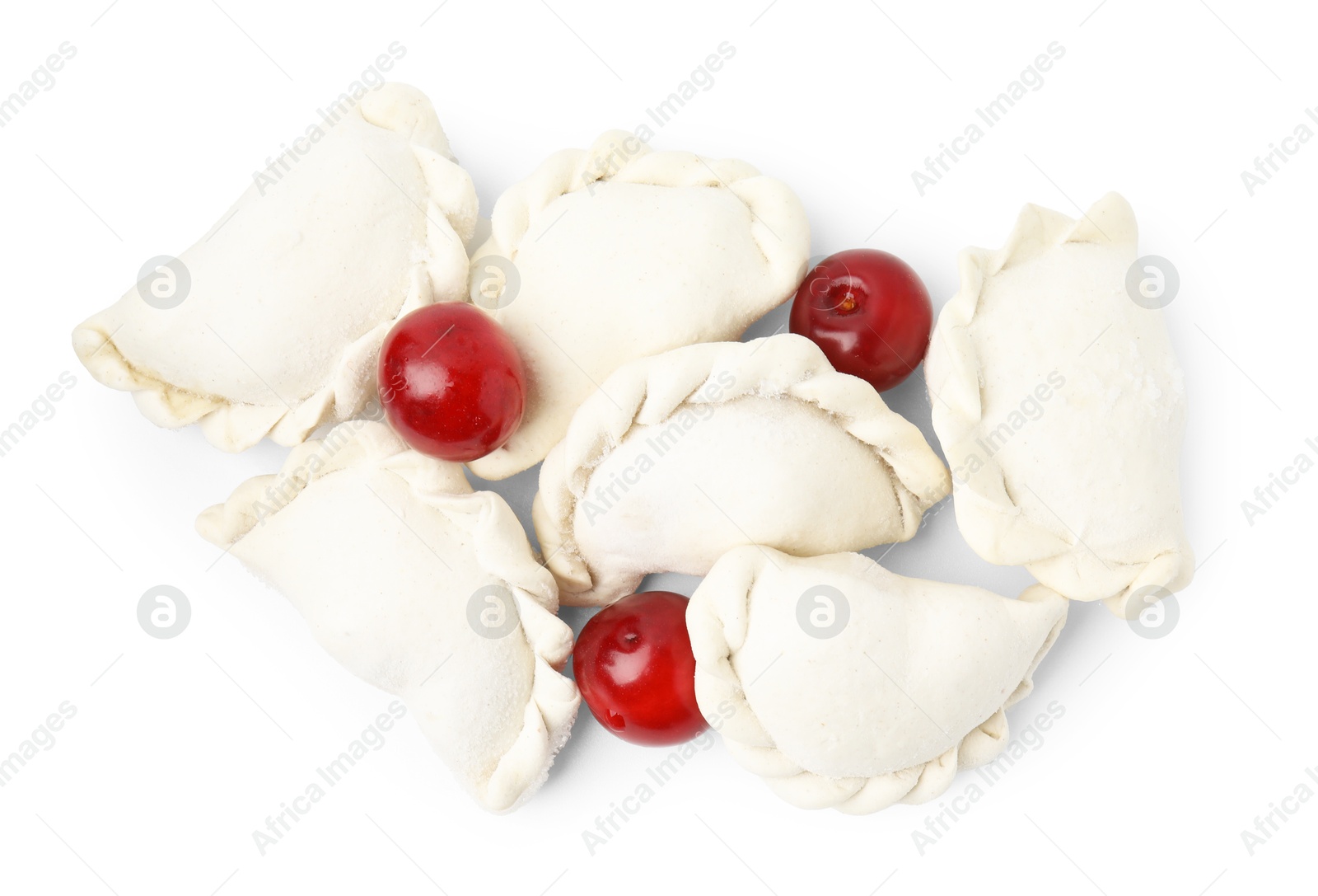 Photo of Frozen dumplings (varenyky) and fresh cherries isolated on white. Ukrainian cuisine