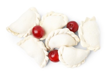 Frozen dumplings (varenyky) and fresh cherries isolated on white. Ukrainian cuisine