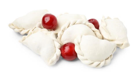 Photo of Frozen dumplings (varenyky) and fresh cherries isolated on white. Ukrainian cuisine