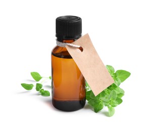 Photo of Essential oil in bottle with empty tag and oregano leaves isolated on white