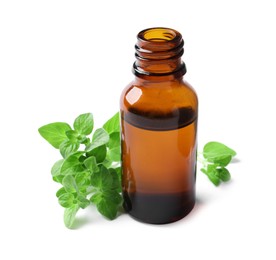 Photo of Essential oil in bottle and oregano leaves isolated on white