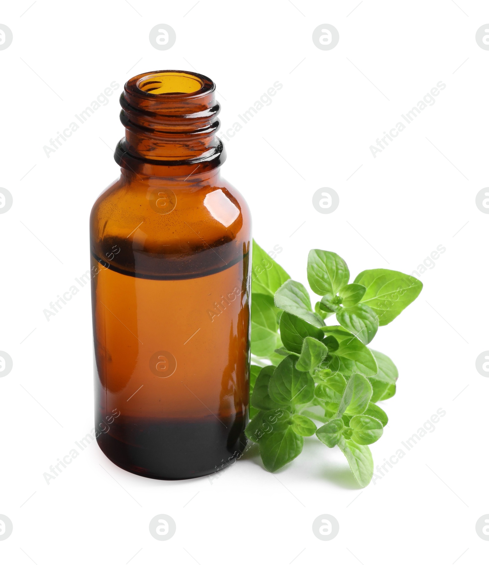 Photo of Essential oil in bottle and oregano leaves isolated on white