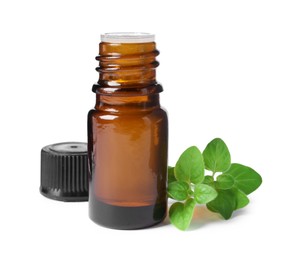 Photo of Essential oil in bottle and oregano leaves isolated on white