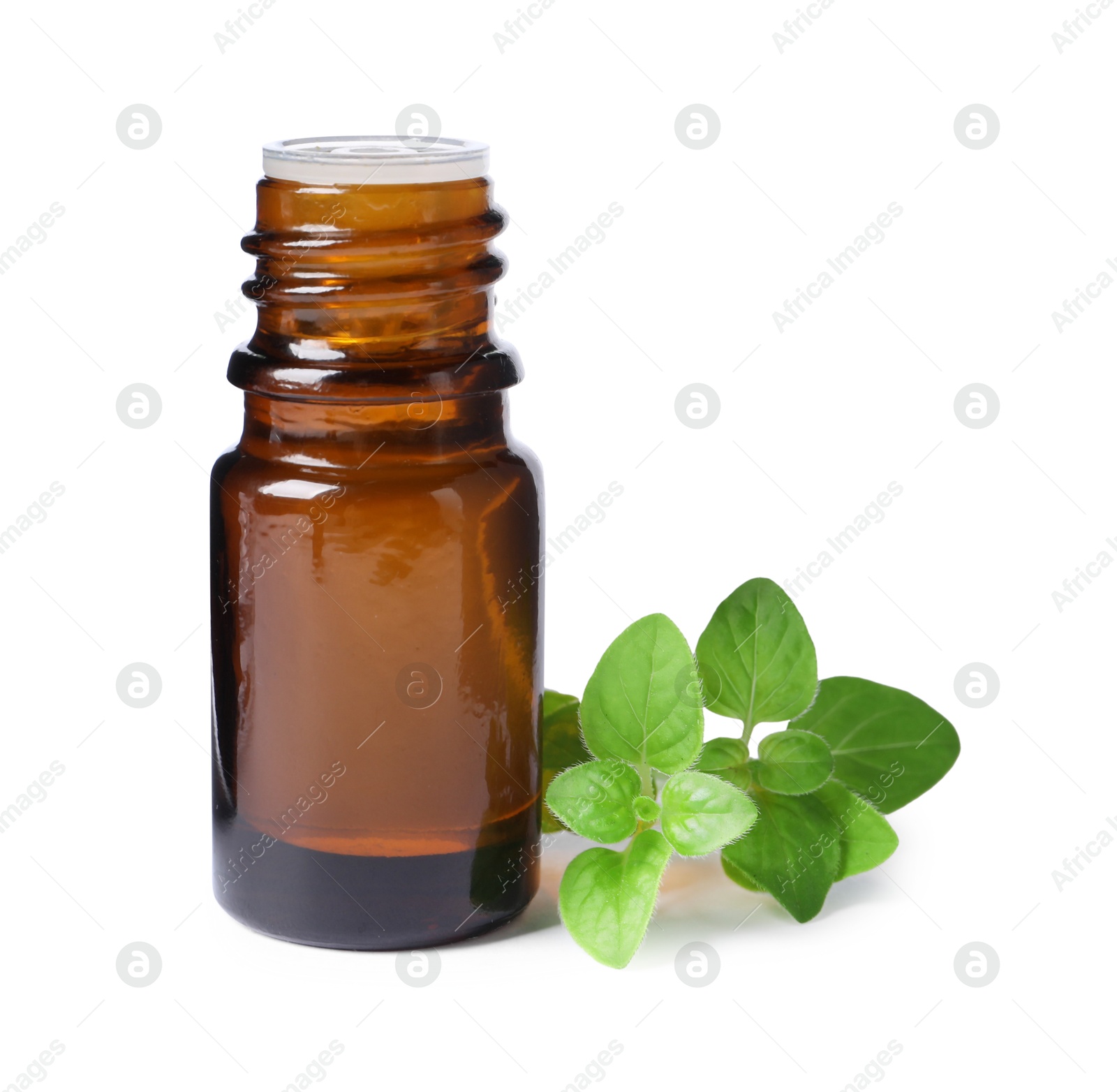 Photo of Essential oil in bottle and oregano leaves isolated on white