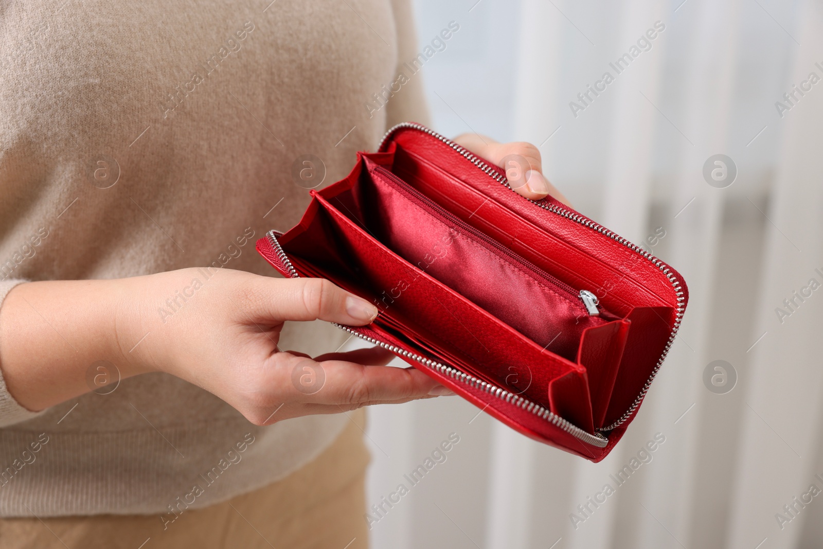 Photo of Woman with empty wallet indoors, closeup view