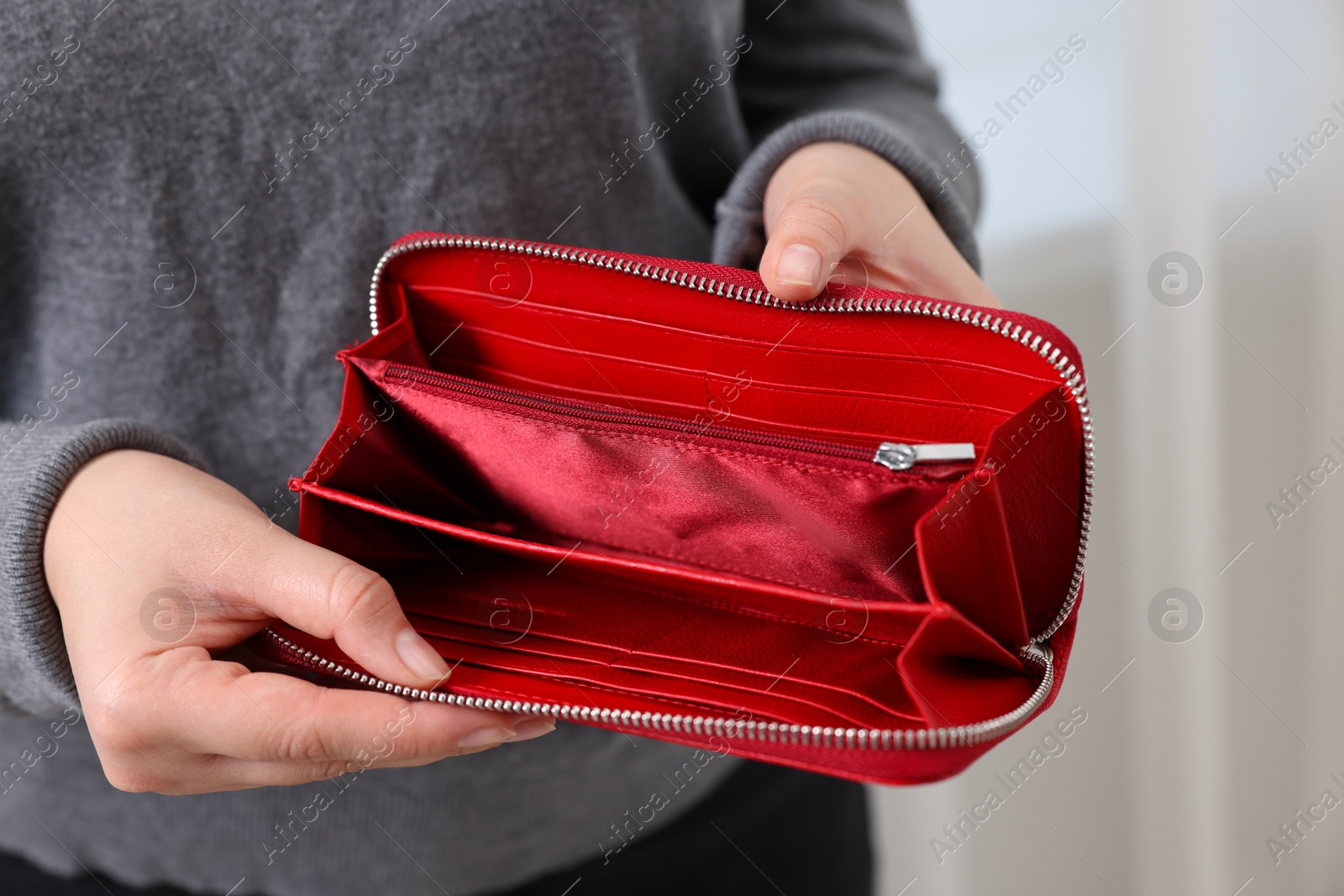 Photo of Woman with empty wallet indoors, closeup view