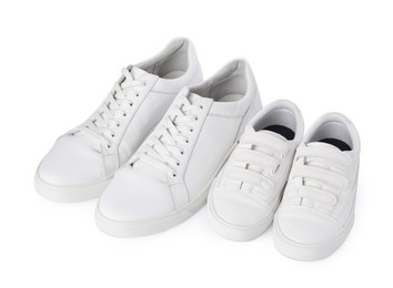 Photo of Big and small sneakers isolated on white