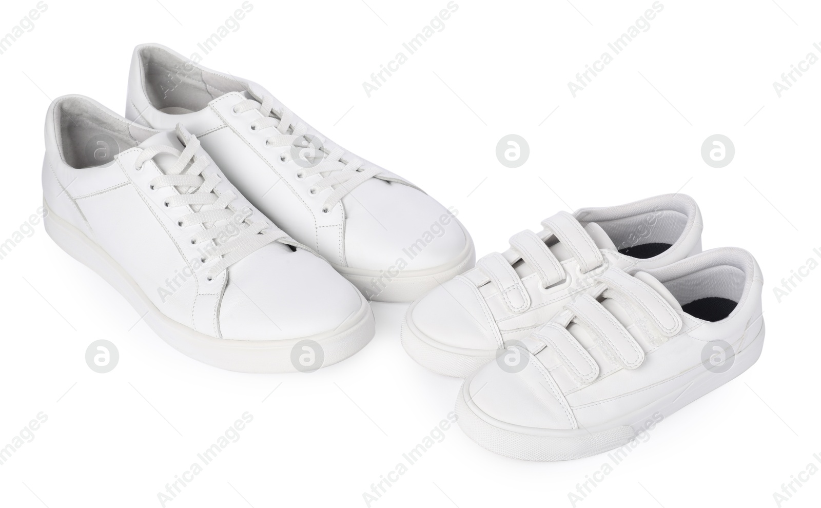 Photo of Big and small sneakers isolated on white