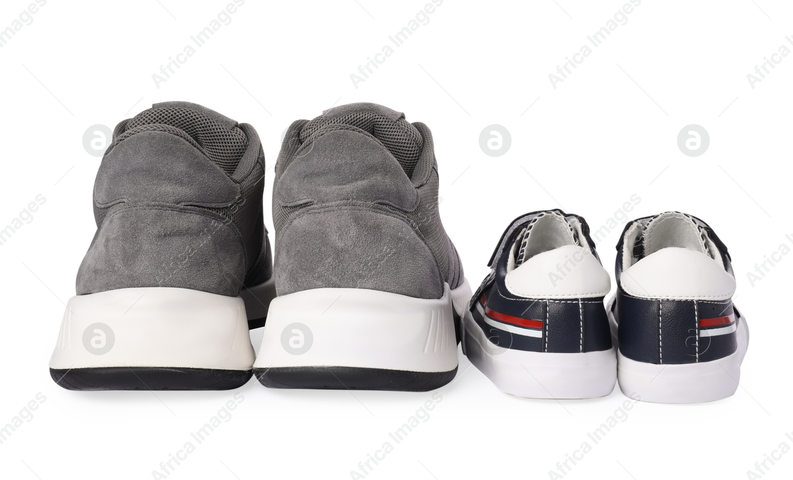 Photo of Big and small sneakers isolated on white