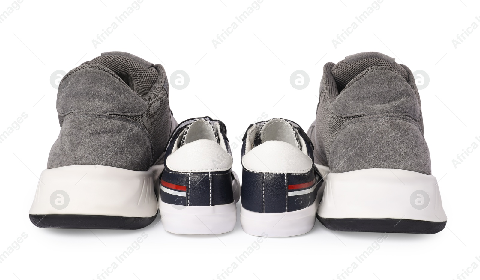 Photo of Big and small sneakers isolated on white