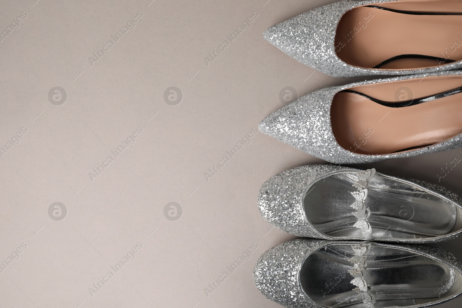 Photo of Big and small shoes on grey background, top view. Space for text