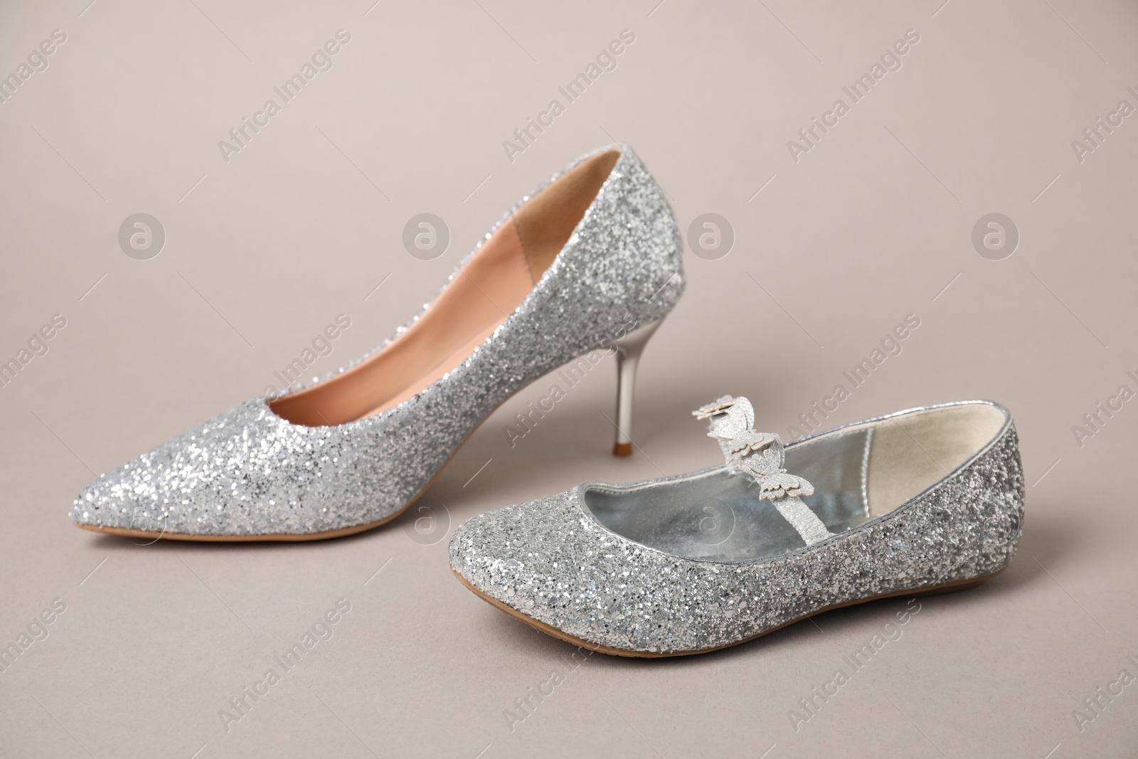 Photo of Big and small shoes on grey background