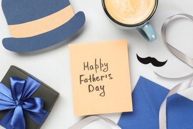 Photo of Greeting card with phrase Happy Father's Day, coffee, gift, paper hat and moustache on light background, flat lay