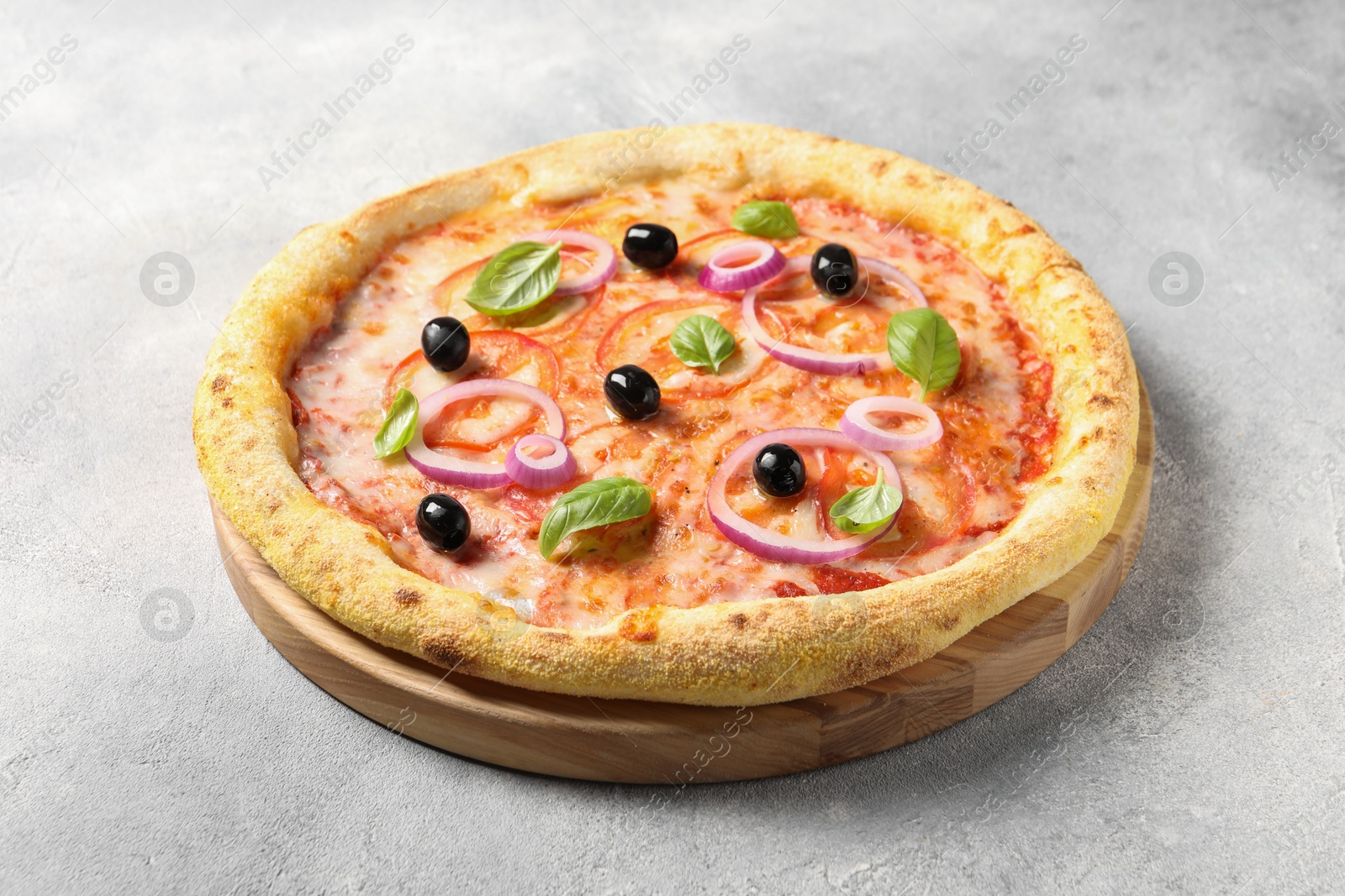 Photo of Delicious vegetarian pizza on light grey table