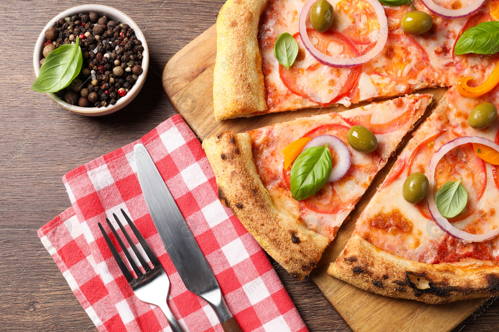 Photo of Delicious vegetarian pizza served on wooden table, flat lay