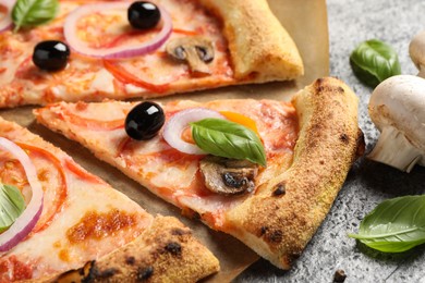 Photo of Cut delicious vegetarian pizza on grey table, closeup