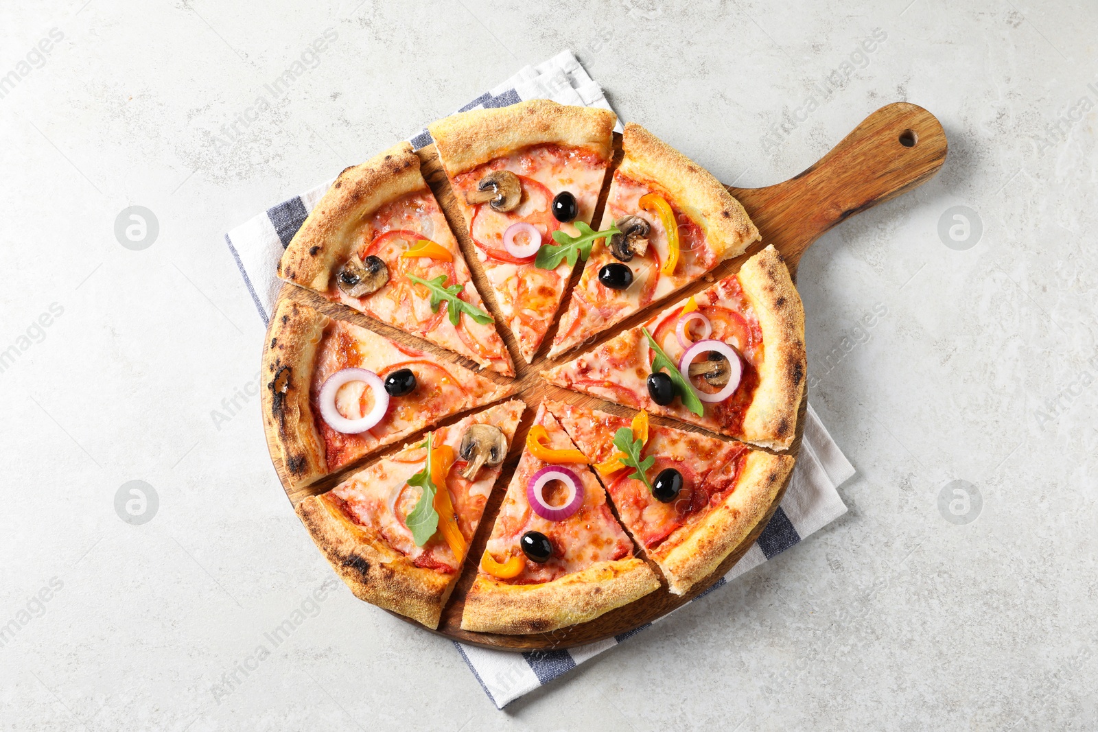 Photo of Cut delicious vegetarian pizza on light table, top view