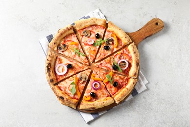 Photo of Cut delicious vegetarian pizza on light table, top view