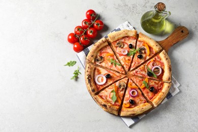 Photo of Cut delicious vegetarian pizza, oil and tomatoes on light table, top view. Space for text