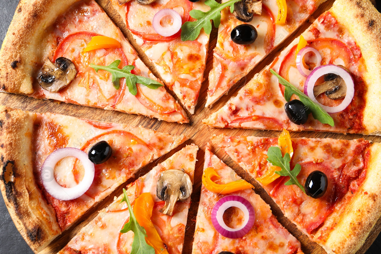 Photo of Cut delicious vegetarian pizza on table, top view