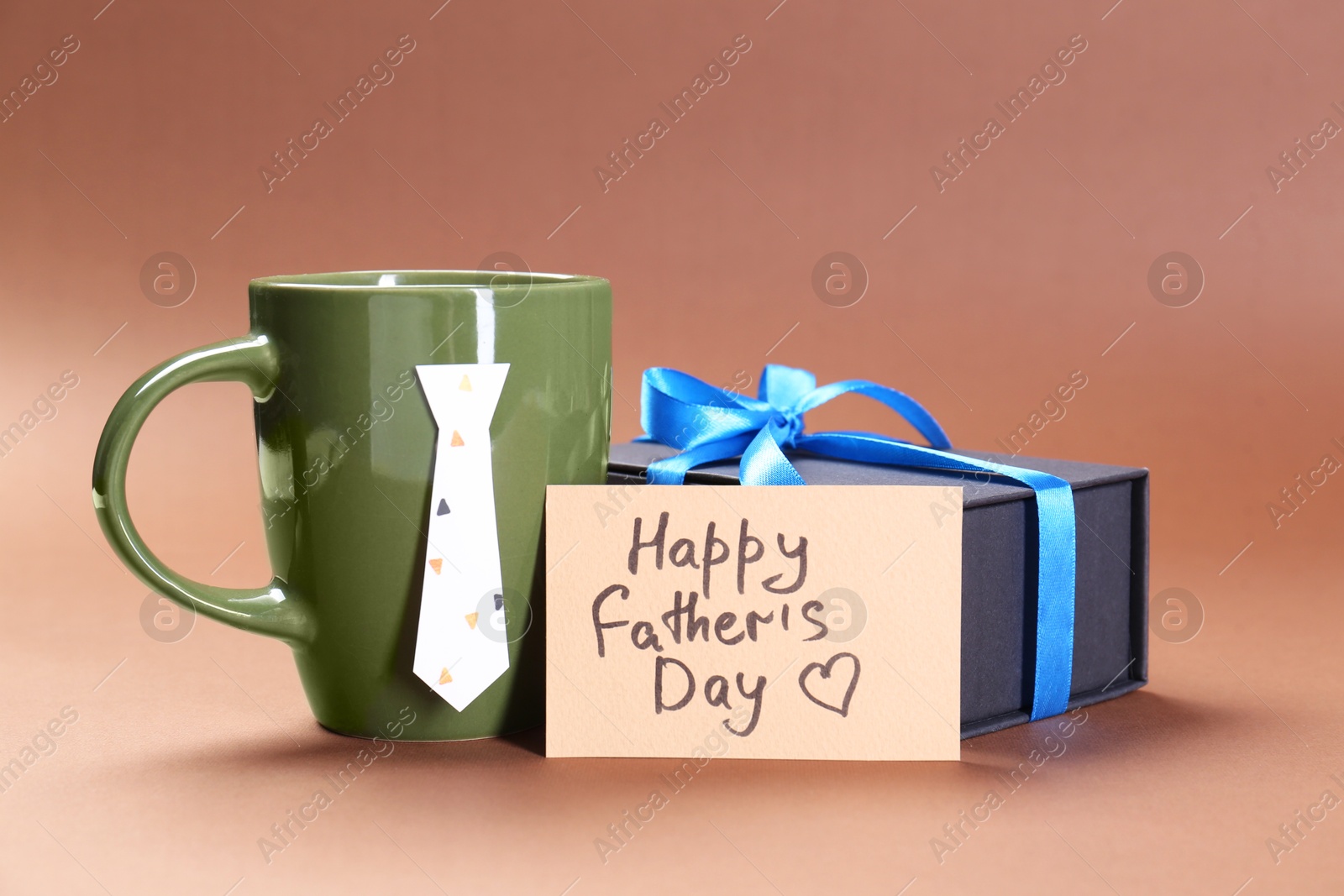 Photo of Card with phrase Happy Father's Day, coffee and gift on brown background