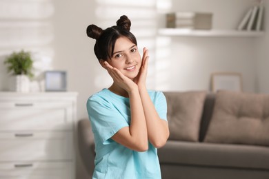 Portrait of smiling teenage girl at home