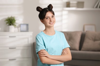 Portrait of smiling teenage girl at home