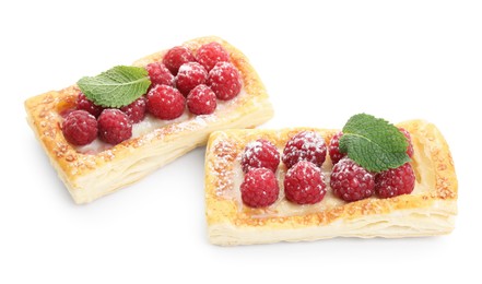 Tasty puff pastries with raspberries and mint isolated on white