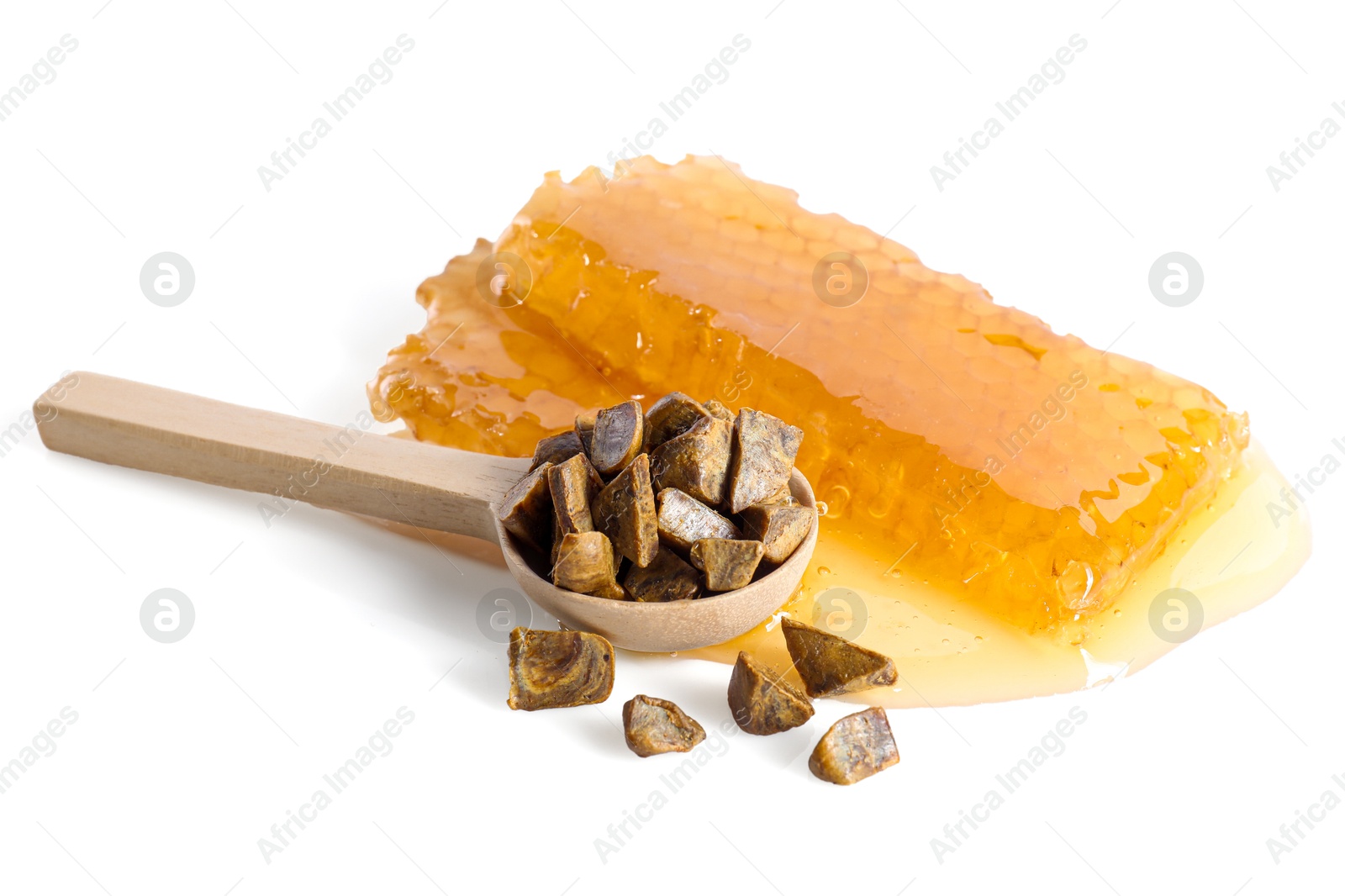 Photo of Sweet honeycombs and spoon with propolis granules isolated on white