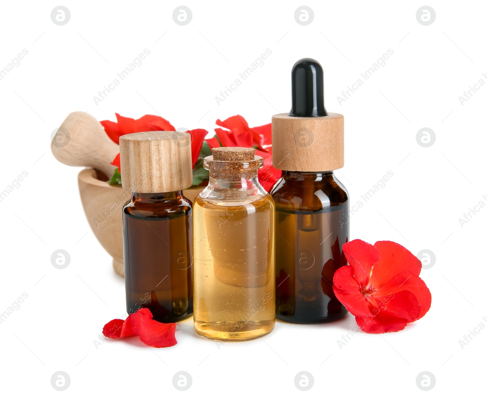 Photo of Bottles of geranium essential oil, mortar and pestle with beautiful flowers isolated on white