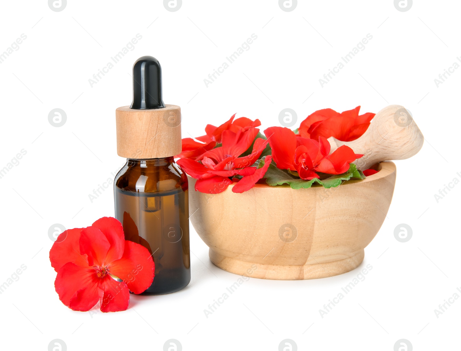 Photo of Bottle of geranium essential oil, mortar and pestle with beautiful flowers isolated on white