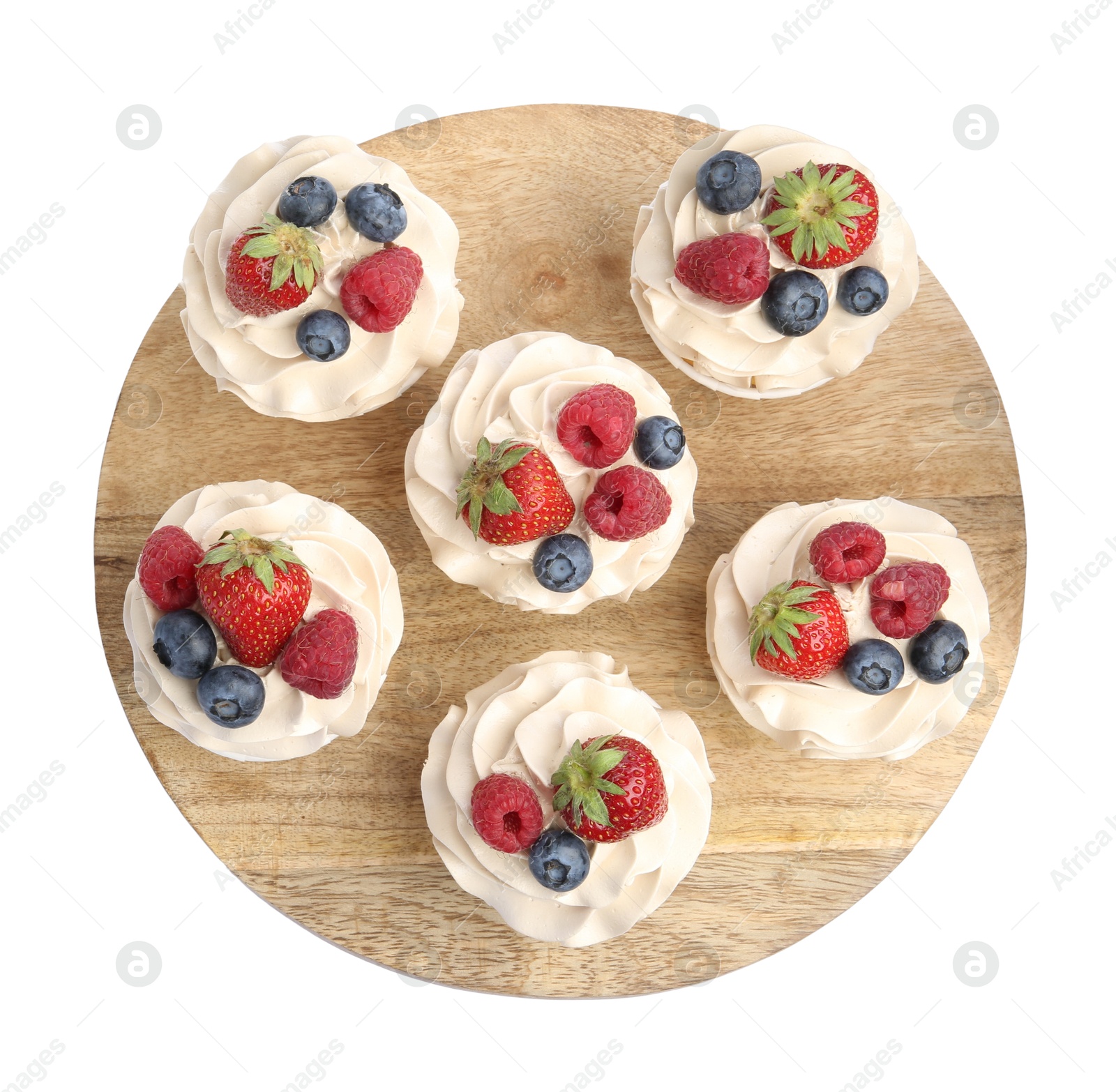 Photo of Tasty cupcakes with different berries isolated on white, top view