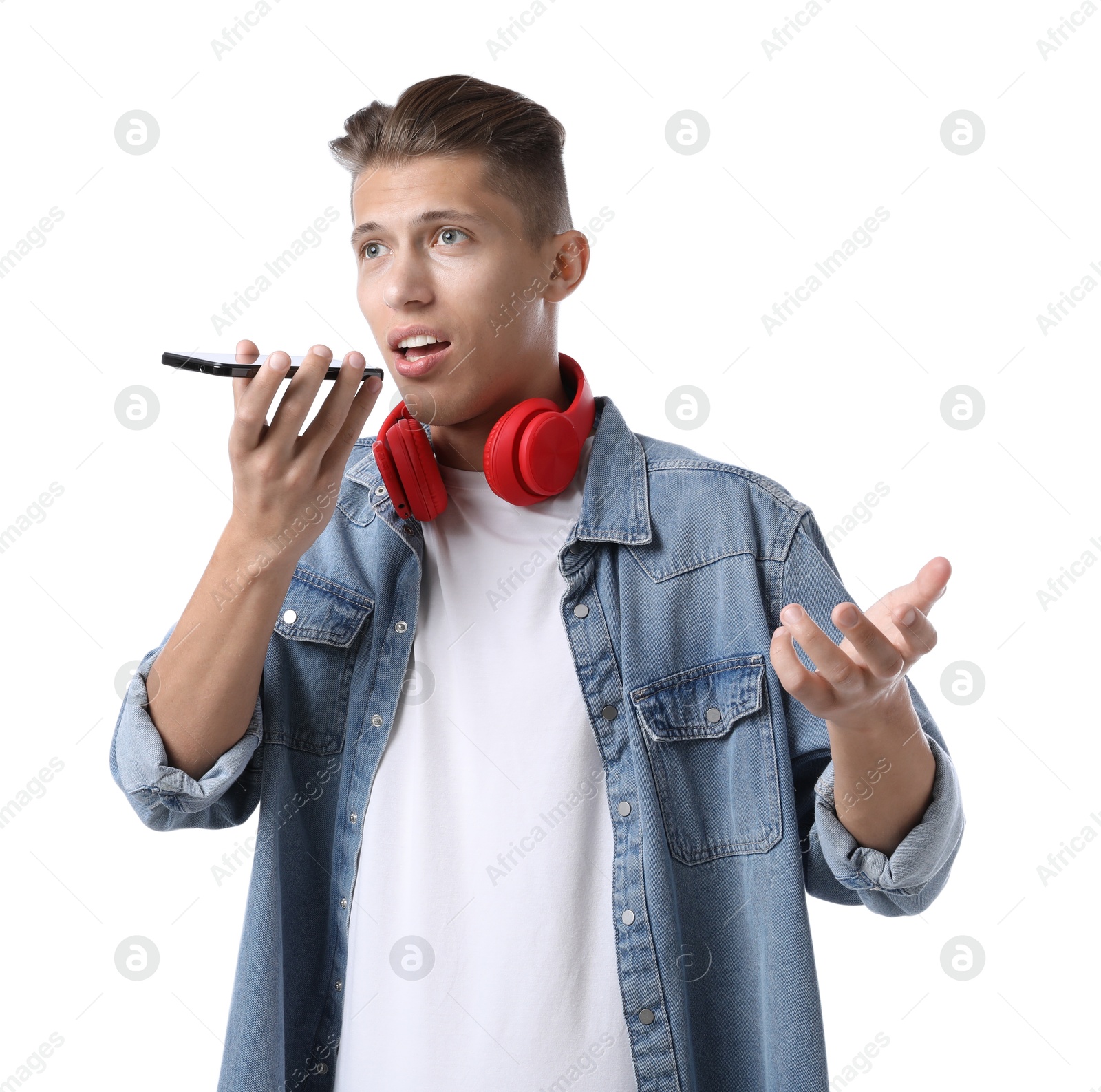 Photo of Young man recording voice message via smartphone on white background