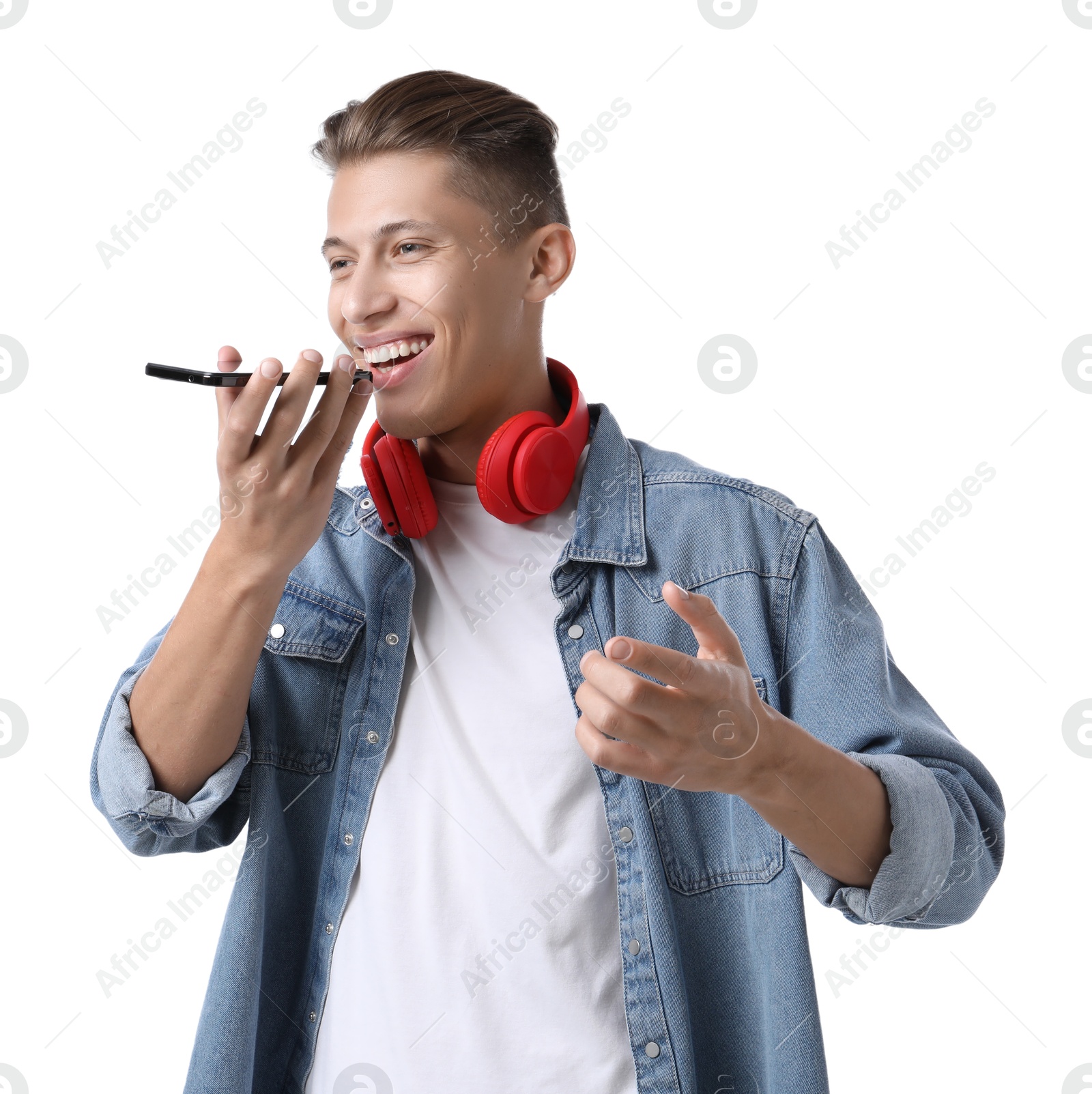 Photo of Young man recording voice message via smartphone on white background