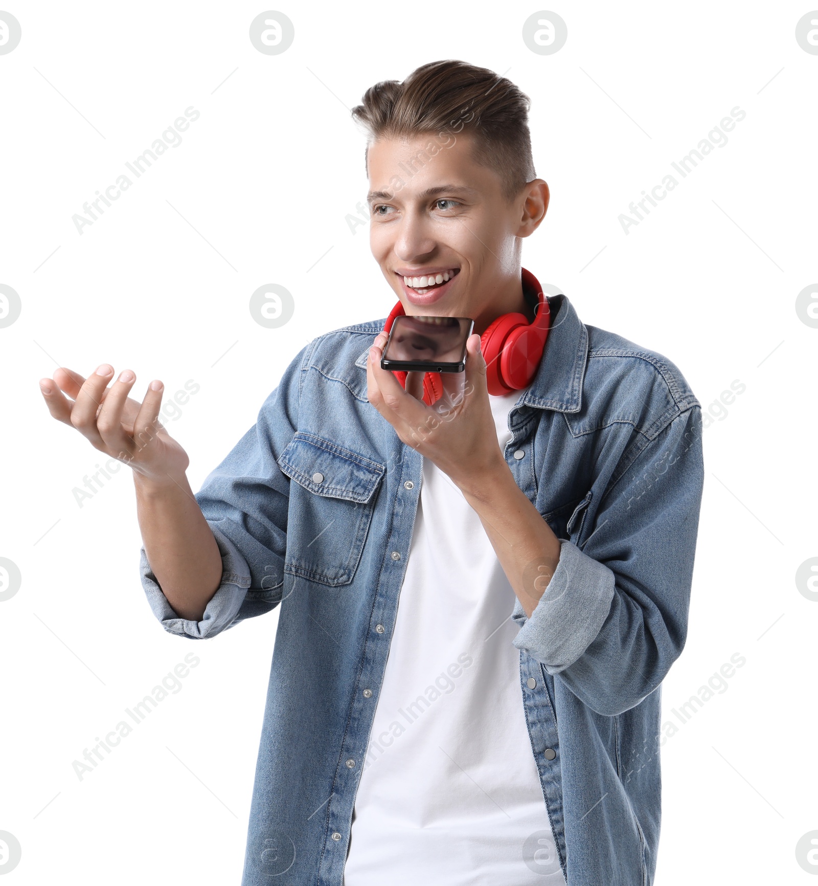 Photo of Young man recording voice message via smartphone on white background