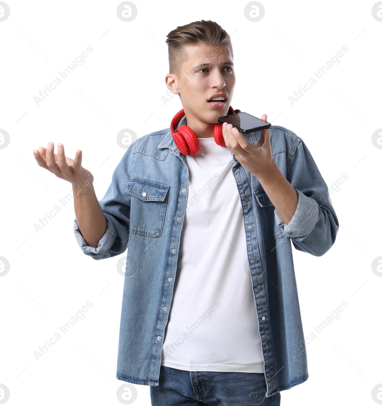 Photo of Young man recording voice message via smartphone on white background