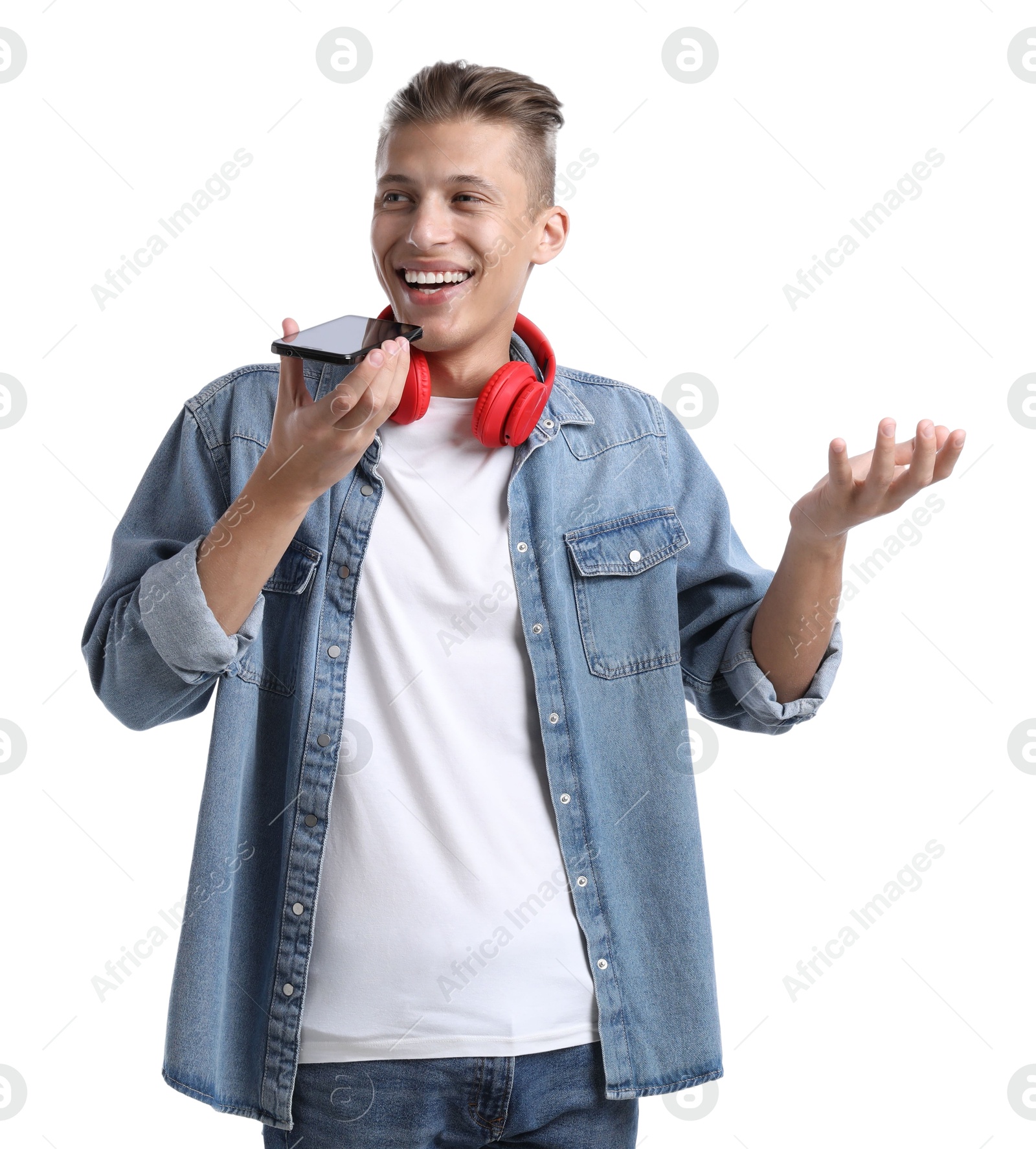 Photo of Young man recording voice message via smartphone on white background